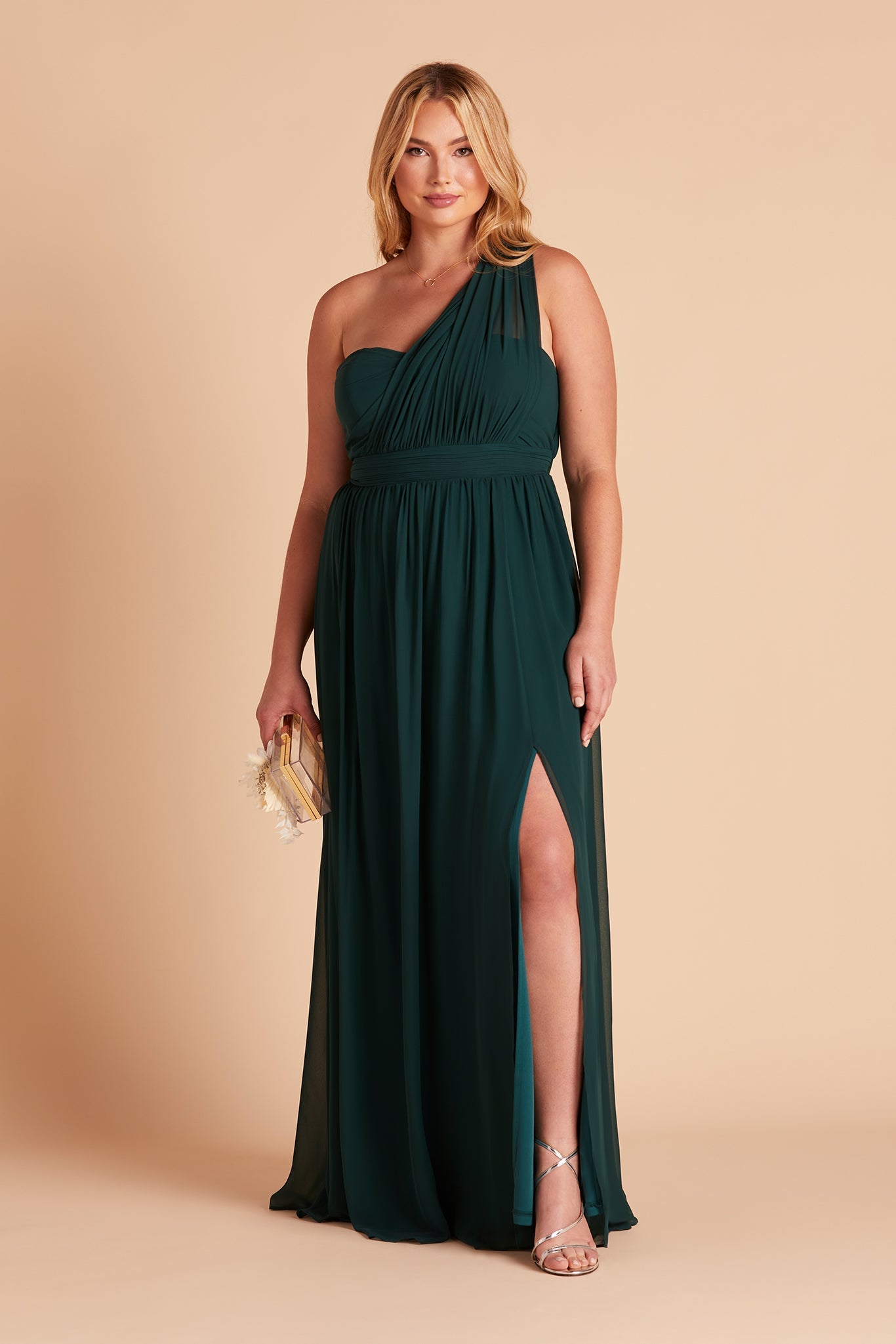 Front view of the floor-length Grace Convertible Plus Size Bridesmaid Dress in emerald chiffon features an optional slit in the flowing floor-length skirt over the left leg.