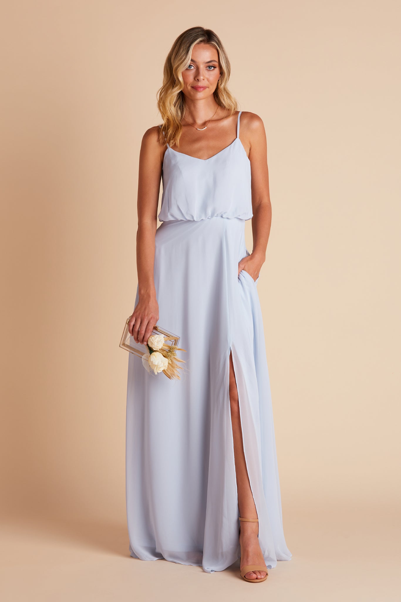 Gwennie bridesmaid dress with slit in ice blue chiffon by Birdy Grey, front view with hand in pocket