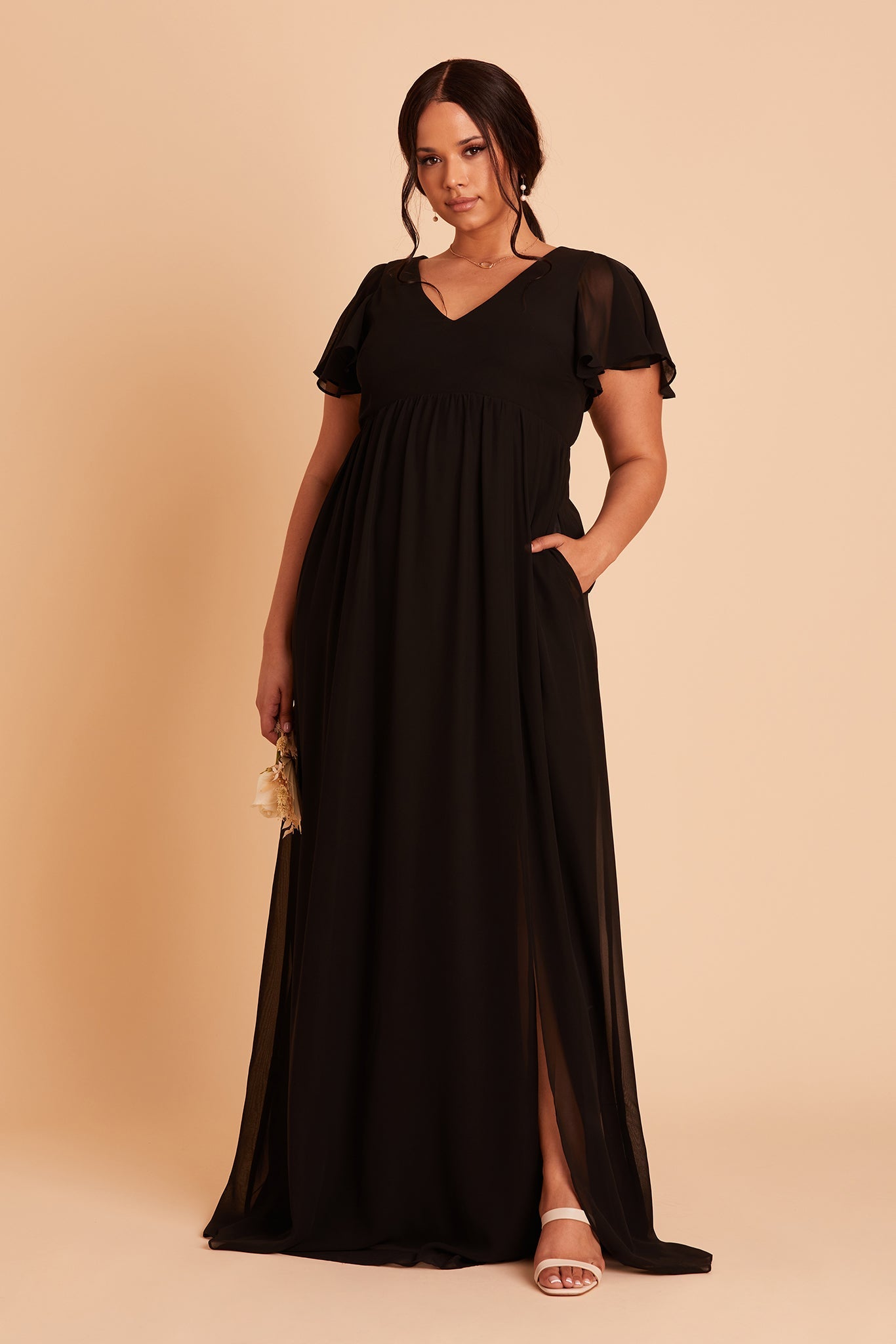 Hannah empire plus size bridesmaid dress in black chiffon by Birdy Grey, hand in pocket, front view