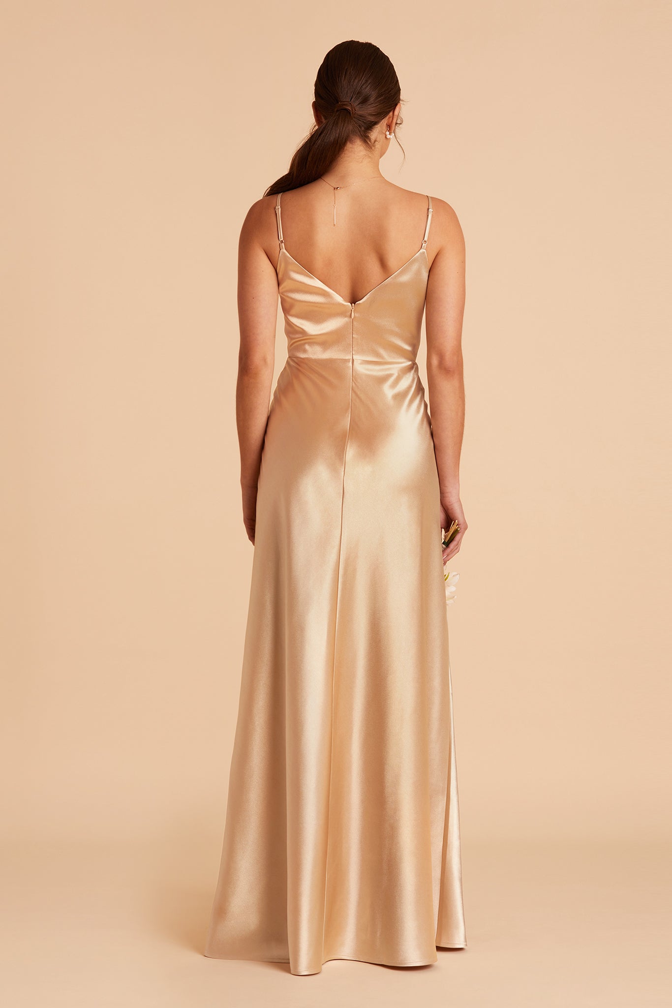 Back view of the Jay Bridesmaid Dress in gold satin flaunts a V-shaped cut just under the shoulder blades and adjustable spaghetti straps.