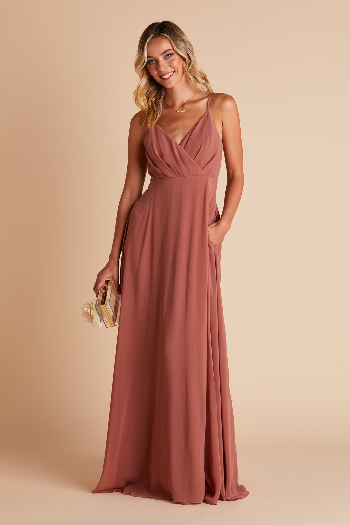 Kaia bridesmaids dress in desert rose chiffon by Birdy Grey, front view with hand in pocket