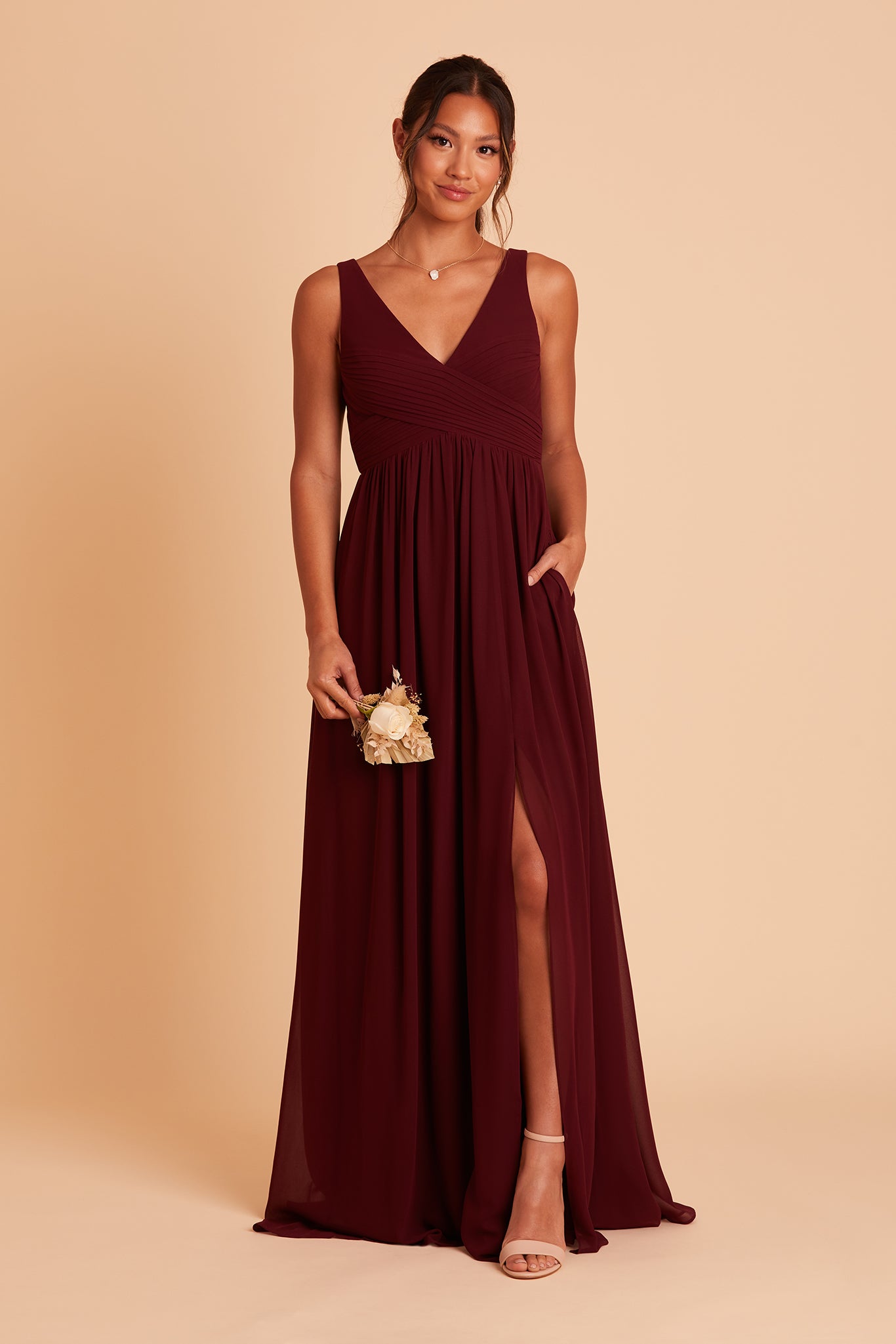 Laurie Empire bridesmaid dress with slit in cabernet chiffon by Birdy Grey, hand in pocket, front view