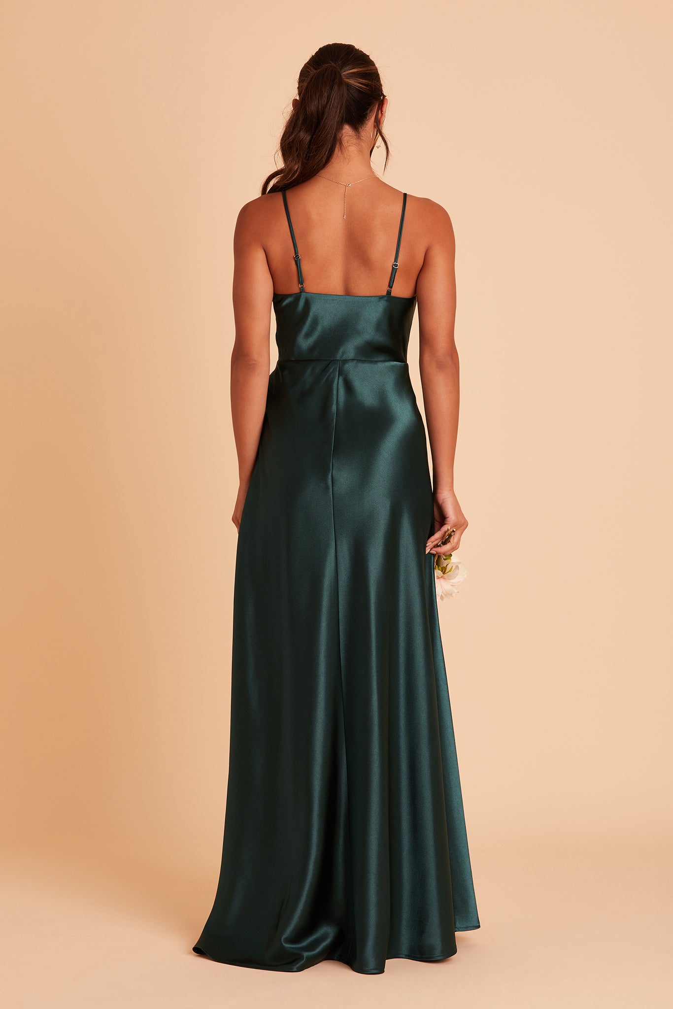 Back view of the Lisa Long Dress in emerald satin shows the back of the dress with adjustable spaghetti straps and a smooth fit in the bodice and waist that attach to a full length skirt.  