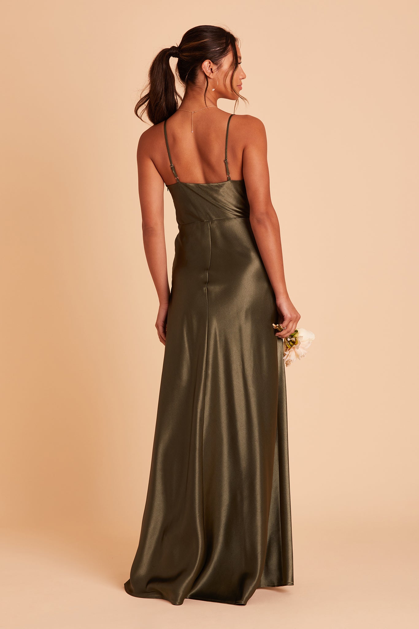 Back view of the Lisa Long Dress in olive satin shows the back of the dress with adjustable spaghetti straps and a smooth fit in the bodice and waist that attach to a full length skirt.  