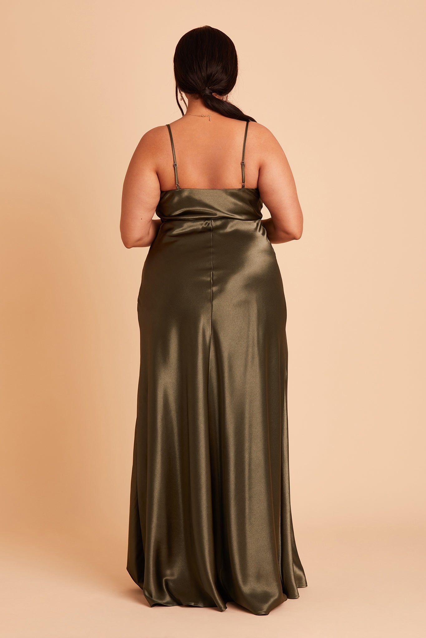 Back view of the Lisa Long Dress Curve in olive satin shows the back of the dress with adjustable spaghetti straps and a smooth fit in the bodice and waist that attach to a full length skirt.  