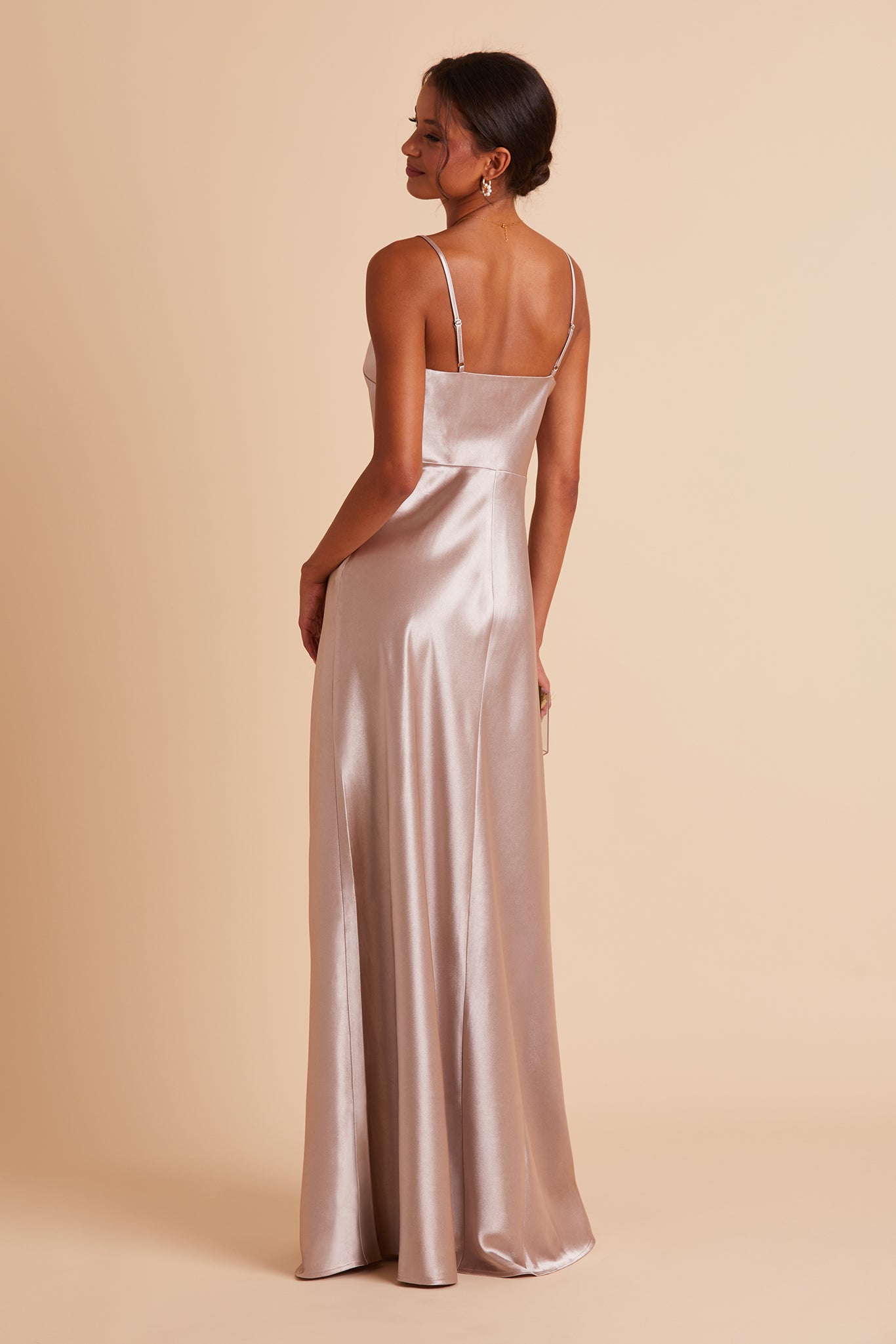 Back view of the Lisa Long Dress in taupe satin shows the back of the dress with adjustable spaghetti straps and a smooth fit in the bodice and waist that attach to a full length skirt.  