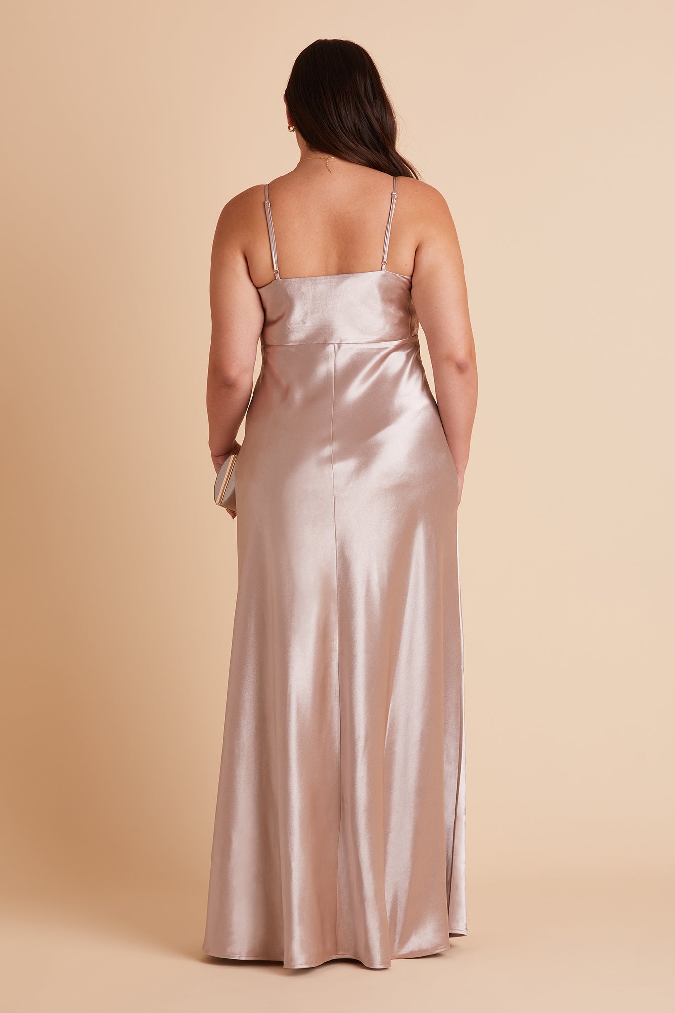 Back view of the Lisa Long Dress Curve in taupe satin shows the back of the dress with adjustable spaghetti straps and a smooth fit in the bodice and waist that attach to a full length skirt.  