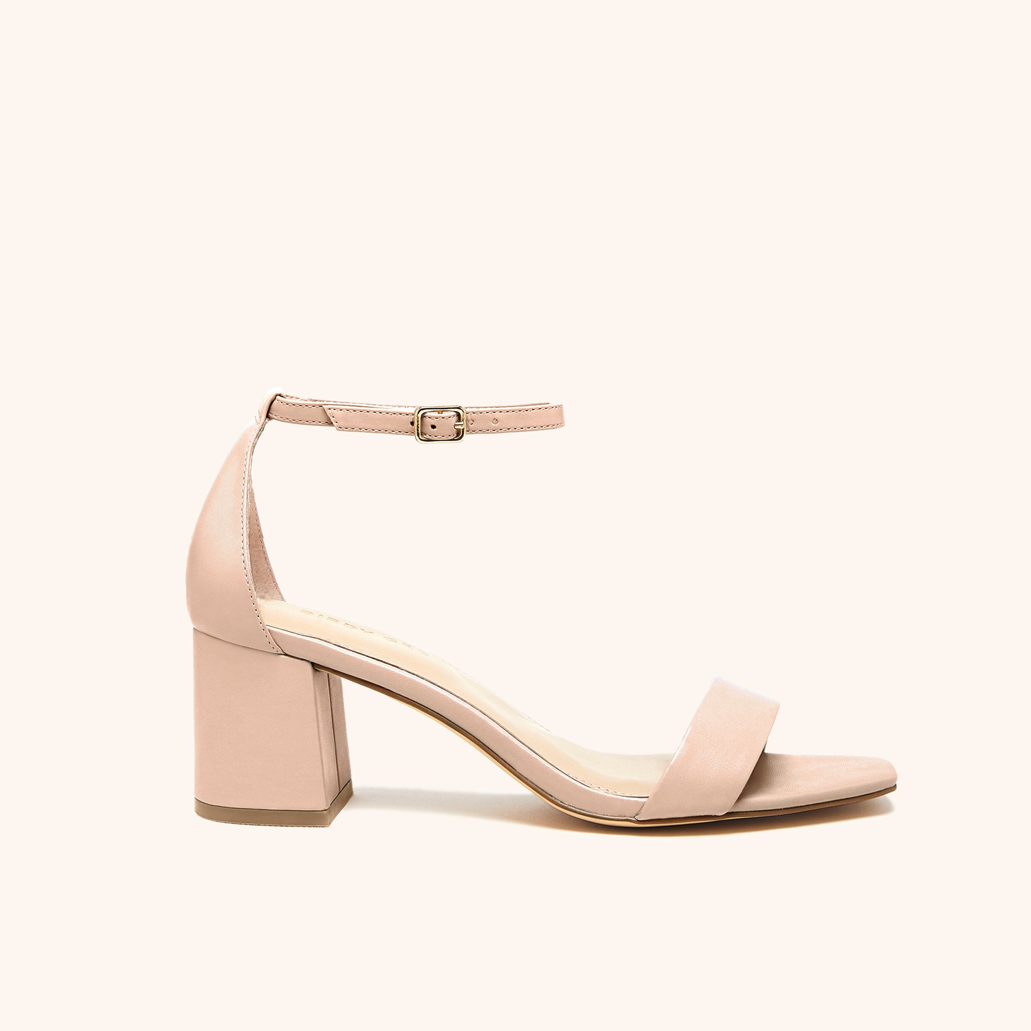 Side view of the Natalie Chunky Heel shoe in nude blush in vegan leather with open toe, enclosed heel, a two and one half inch block chunky heel, and adjustable buckle ankle strap. 