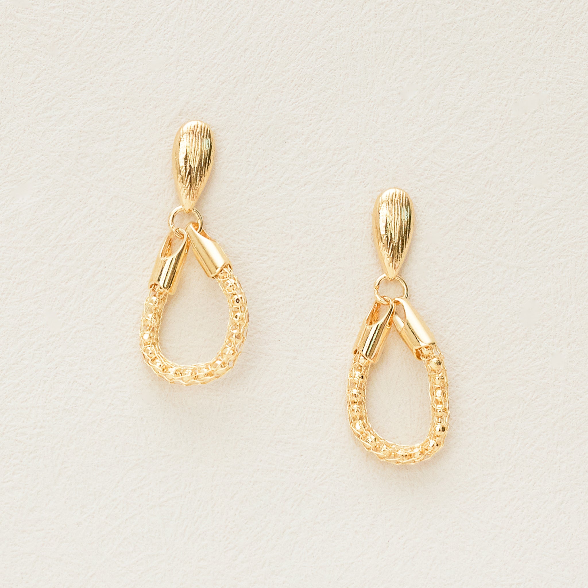 Gold teardrop loop earrings, front view
