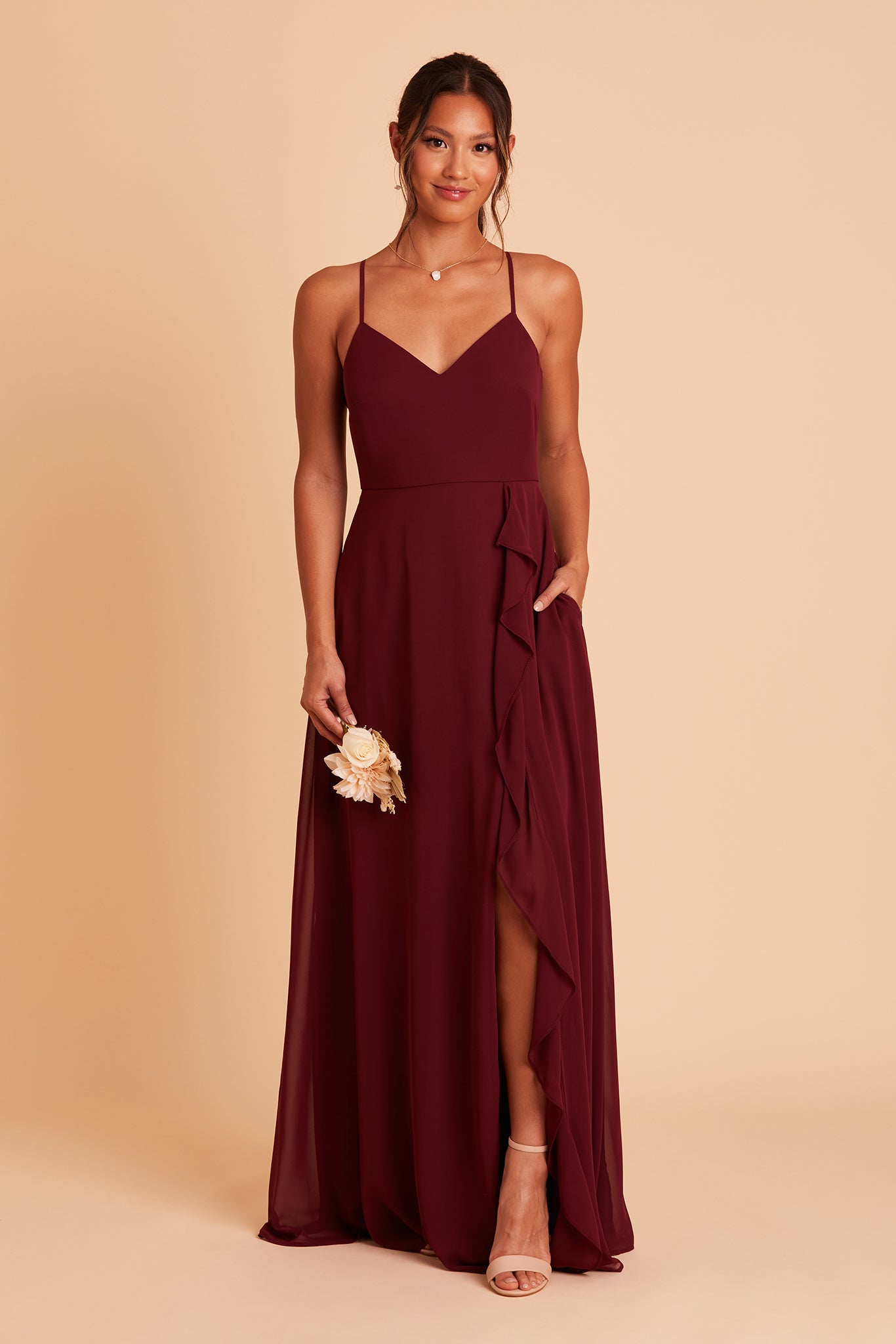 Theresa bridesmaid dress with slit in cabernet burgundy chiffon by Birdy Grey, hand in pocket, front view