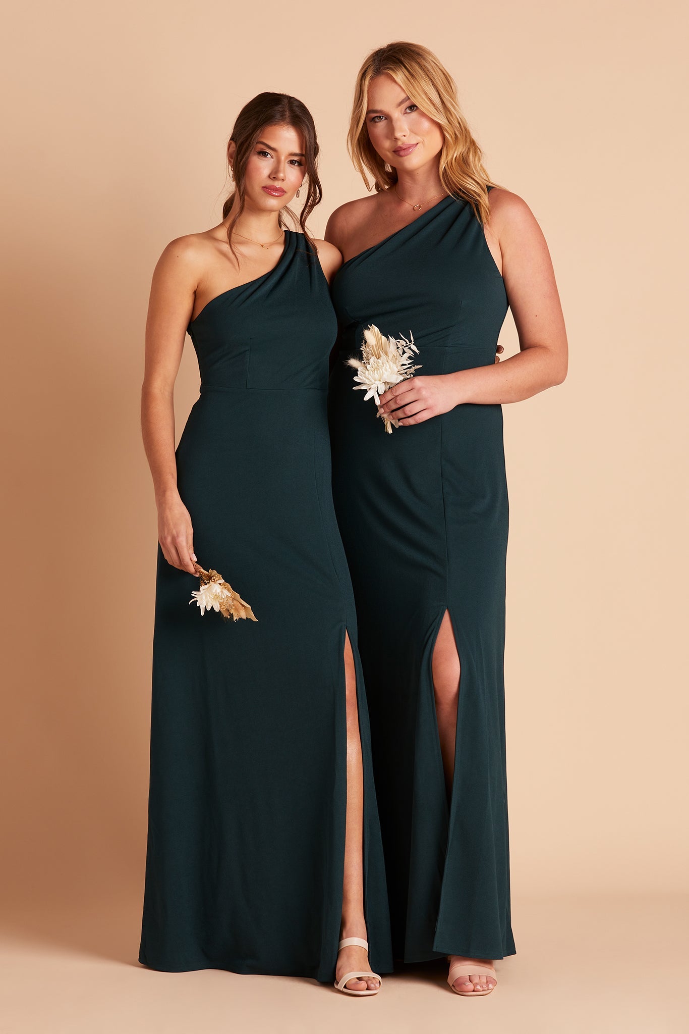 Two women in Kira bridesmaid dresses with slit in emerald green crepe by Birdy Grey, front view