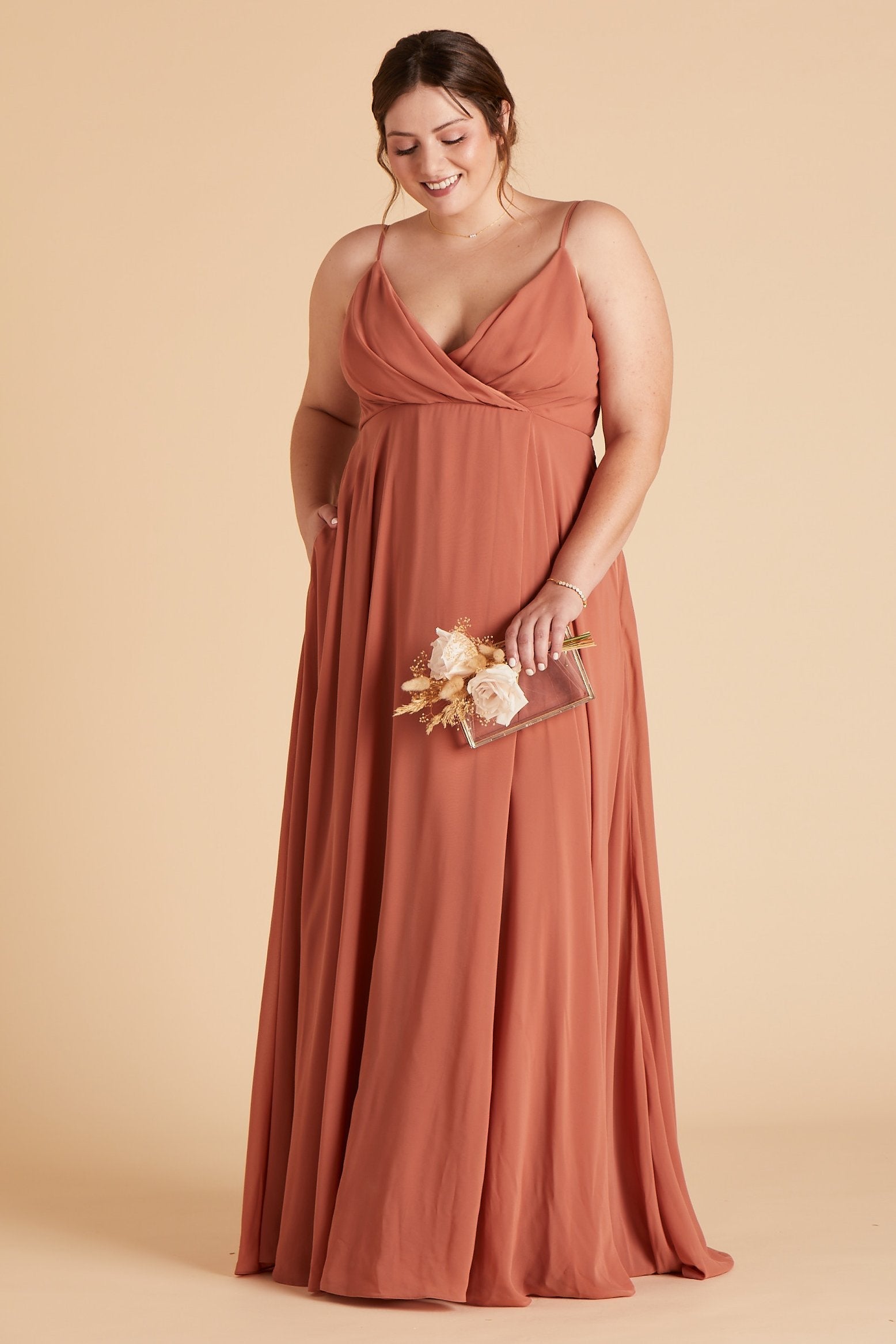 Back view of the Kaia Dress Curve in terracotta chiffon shows the hook and eye closure and hidden zipper in the center seam of the dress bodice and skirt.