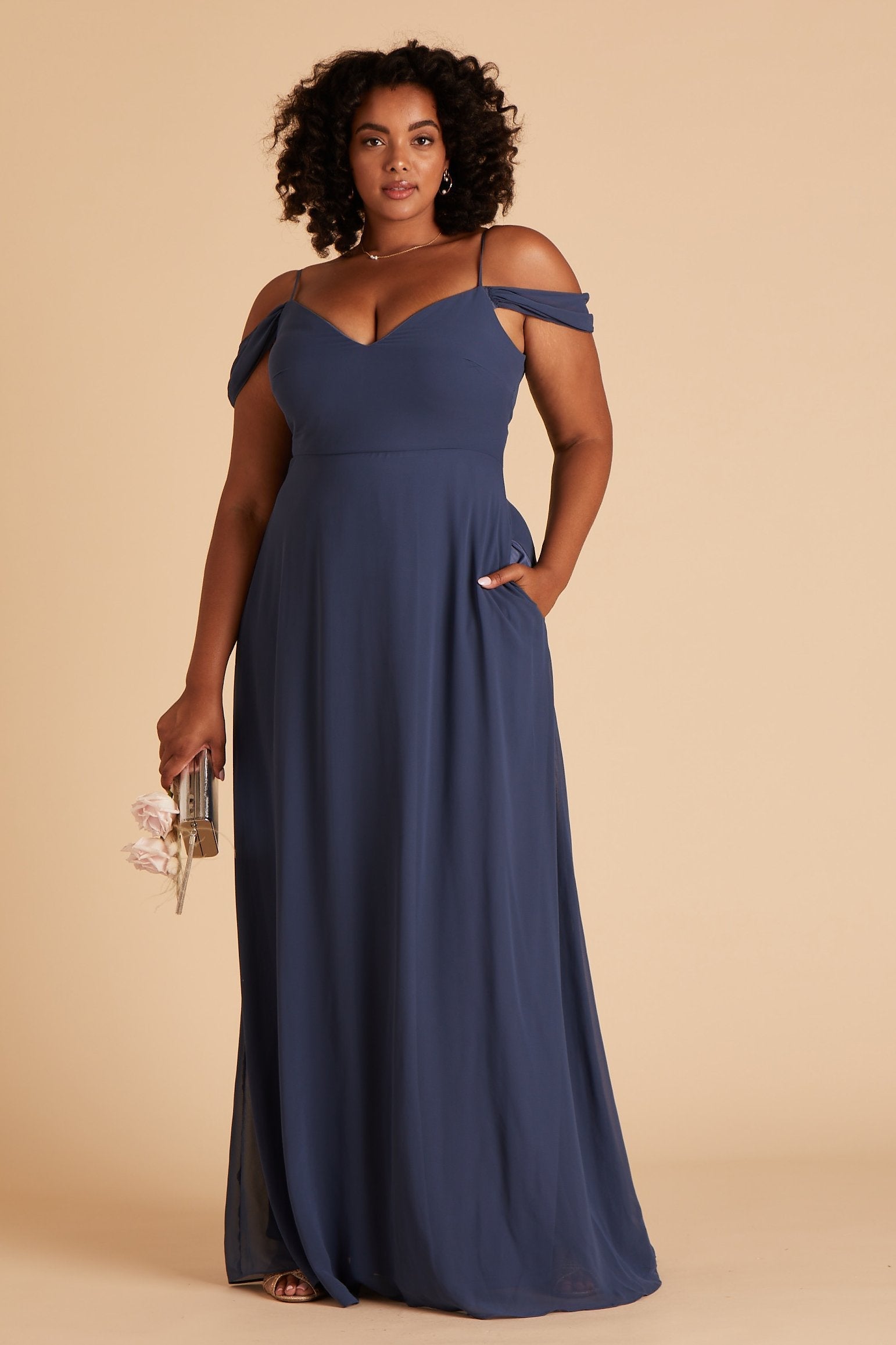 Devin convertible plus size bridesmaids dress in slate blue chiffon by Birdy Grey, front view with hand in pocket