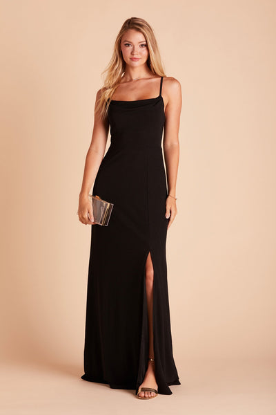 Front view of the floor-length Ash Bridesmaid Dress in black crepe by Birdy Grey with a slightly draped cowl neck front. The flowing skirt features a slit over the front left leg. 