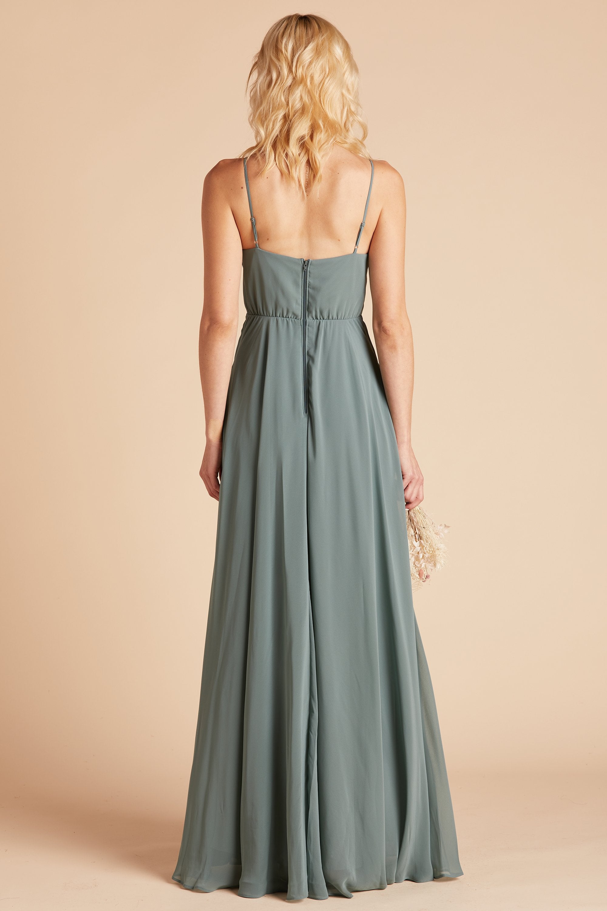 Back view of the Kaia Dress in sea glass chiffon shows the hook and eye closure and zipper in the center seam of the dress bodice and skirt. 