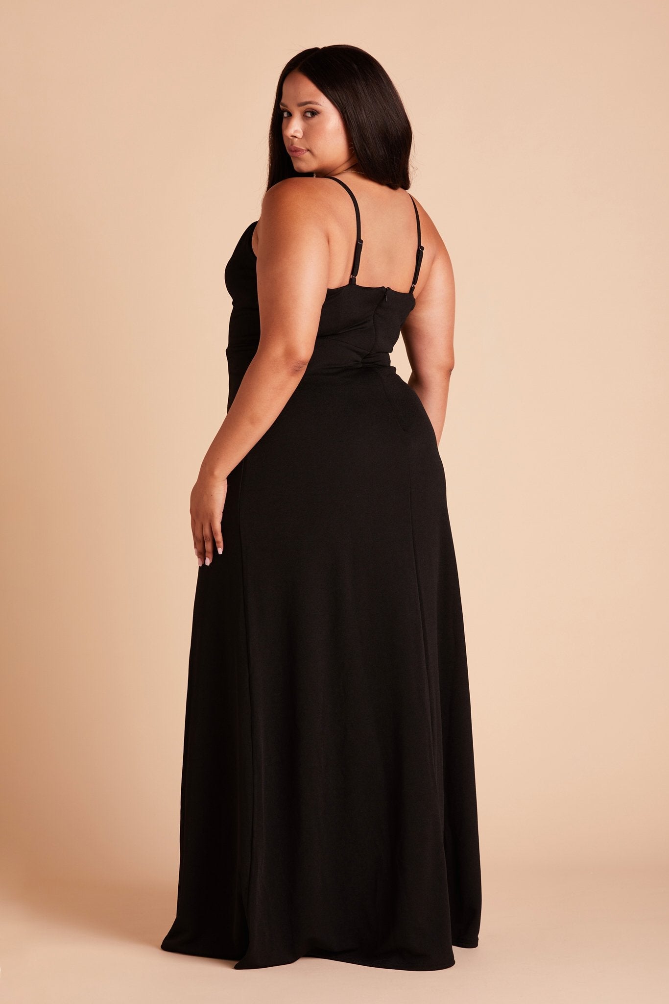 Back view of the Ash Bridesmaid Dress in black crepe shows skinny adjustable straps as well as an open back just below shoulder blades.