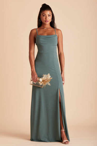 Front view of the floor-length Ash Bridesmaid Dress in sea glass crepe by Birdy Grey with a slightly draped cowl neck front. The flowing skirt features a slit over the front left leg. 