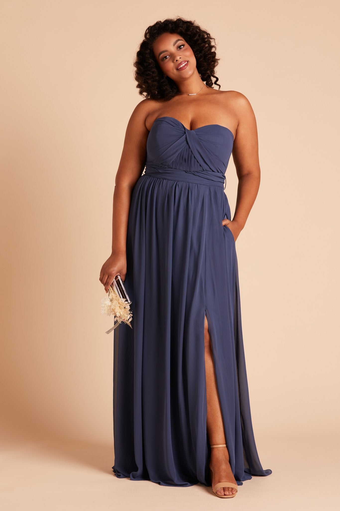 Grace convertible plus size bridesmaid dress with slit in slate blue chiffon by Birdy Grey, front view with hand in pocket