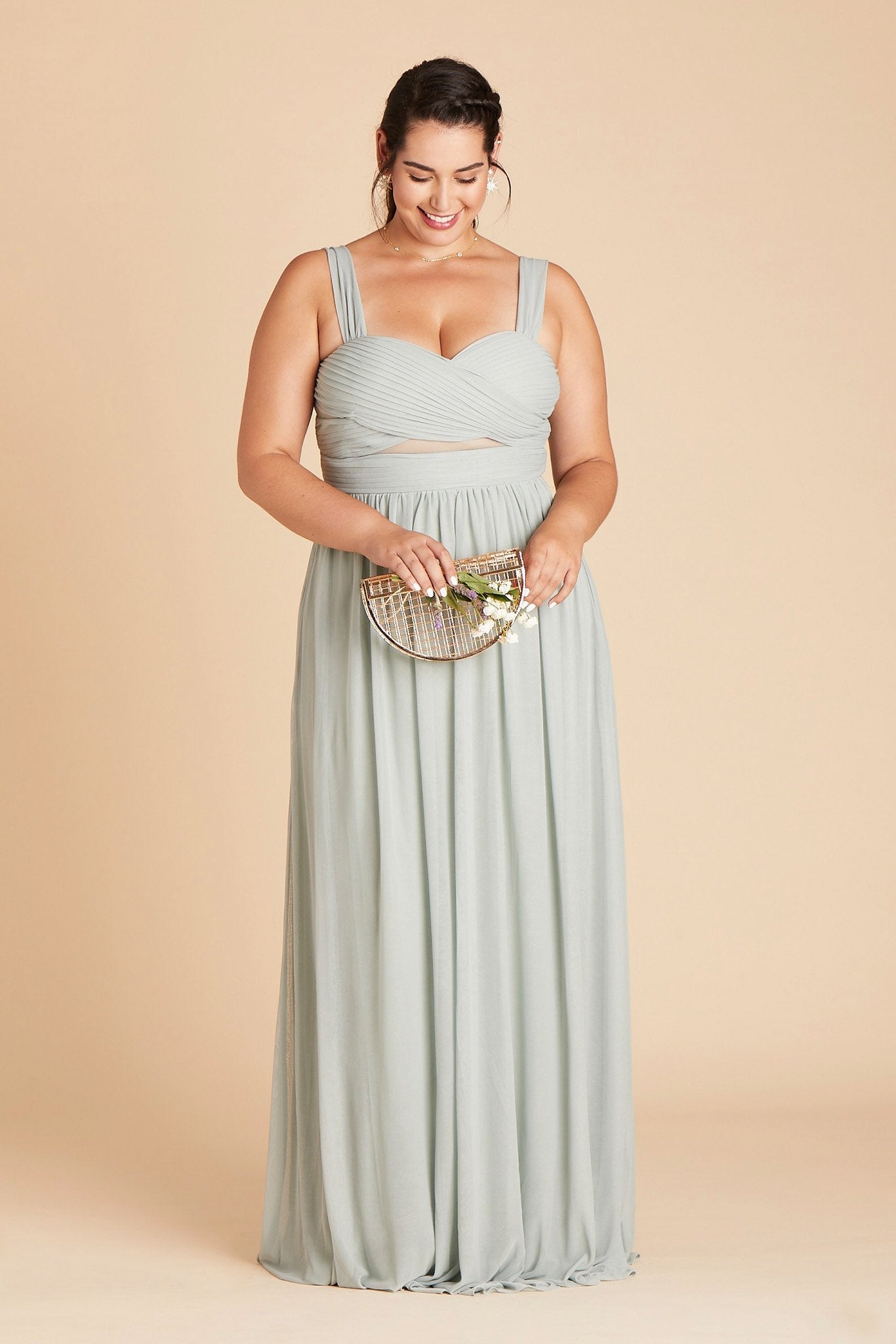 Front view of the Elsye Plus Size Bridesmaid Dress in sage mesh worn by a curvy model with a light skin tone.