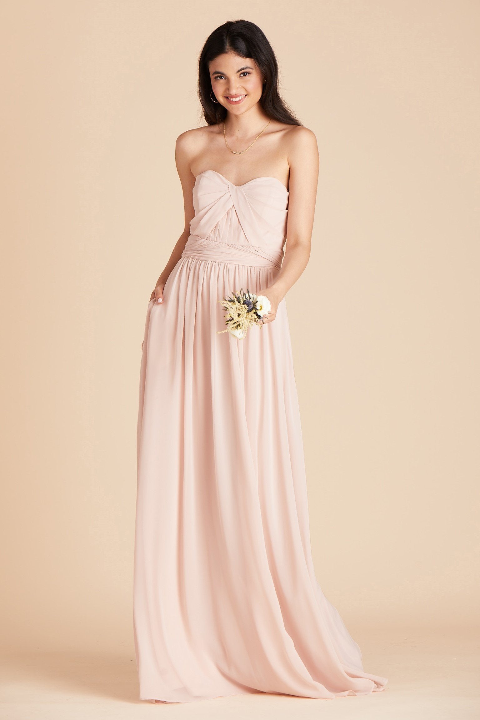 Grace convertible bridesmaid dress in pale blush pink chiffon by Birdy Grey, front view with hand in pocket