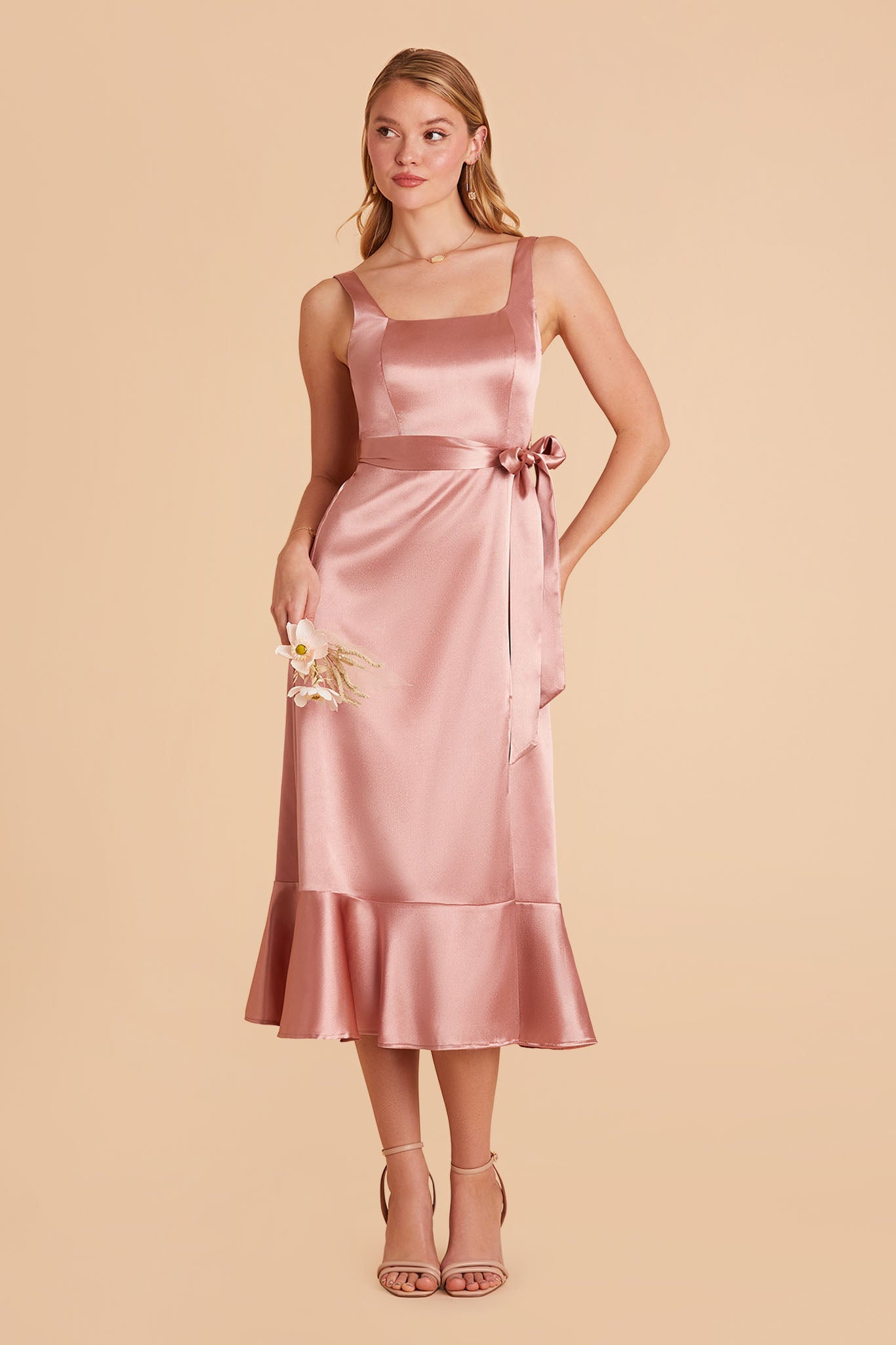 Pink satin convertible pinafore-style midi bridesmaid dress with bow and ruffles