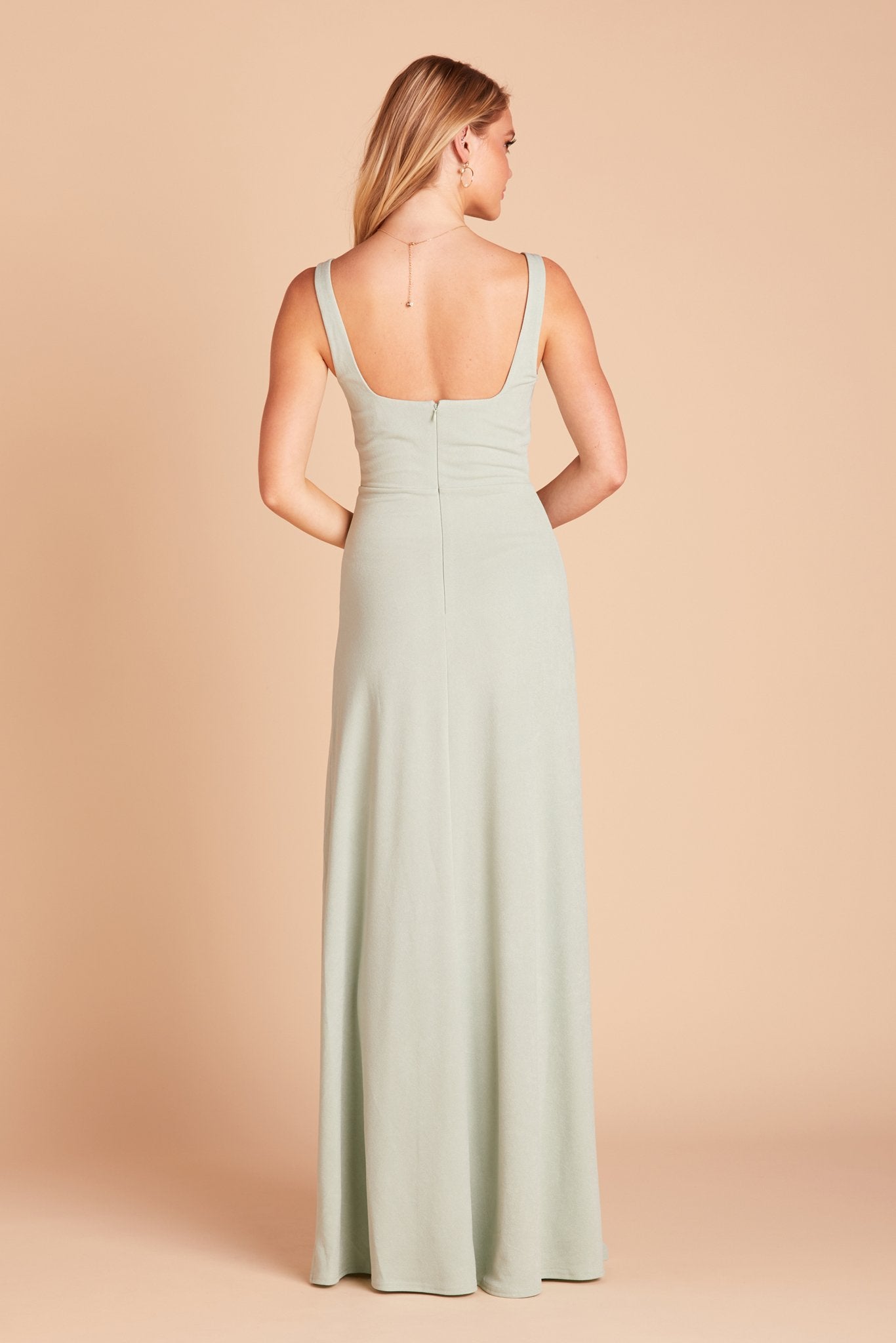 Back view of the Alex Convertible Bridesmaid Dress in crepe sage shows that the shoulder ties feature a square cut that falls just below the shoulder blades.