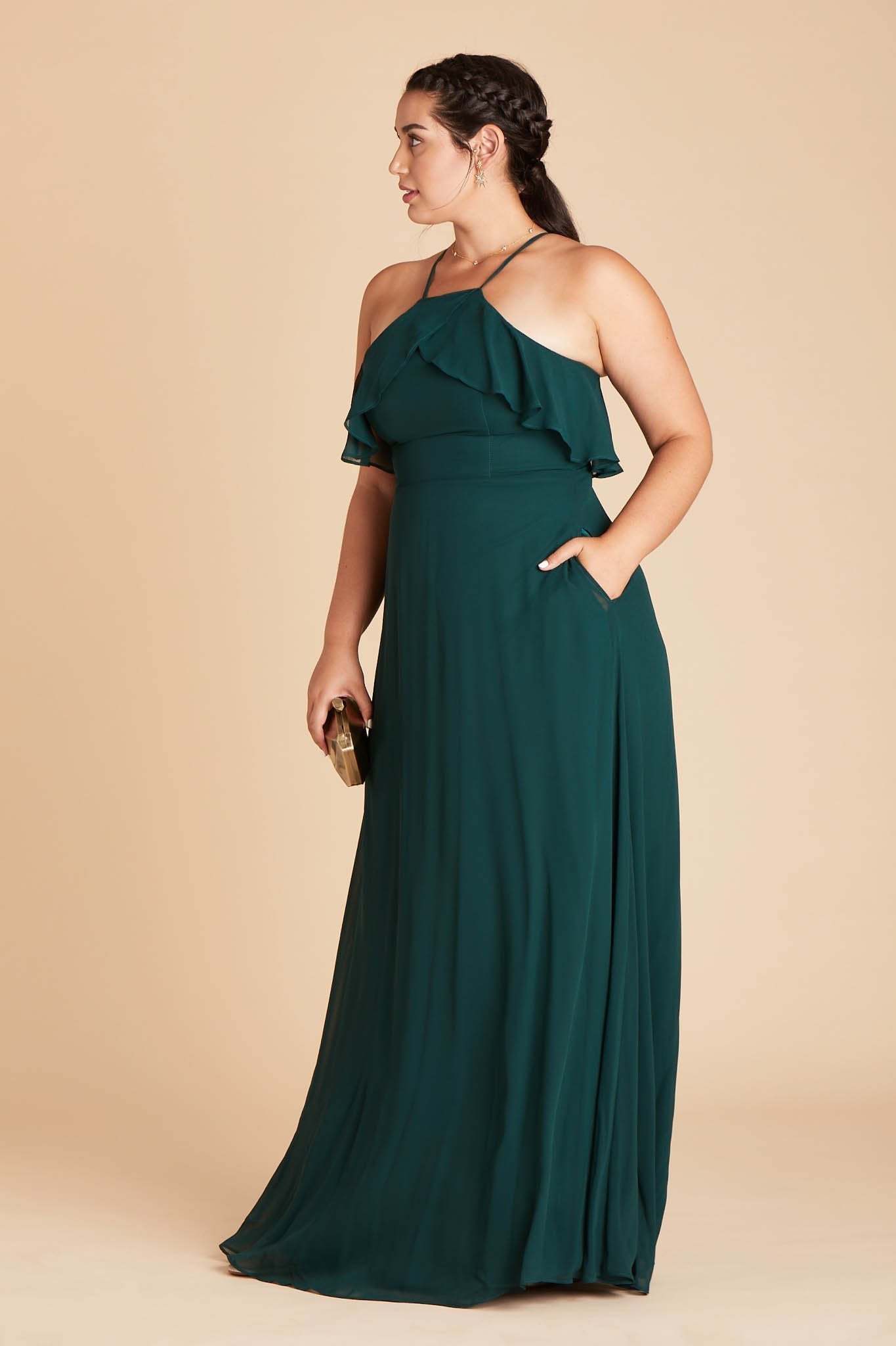 Jules convertible plus size bridesmaid dress in emerald green chiffon by Birdy Grey, side view with hand in pocket