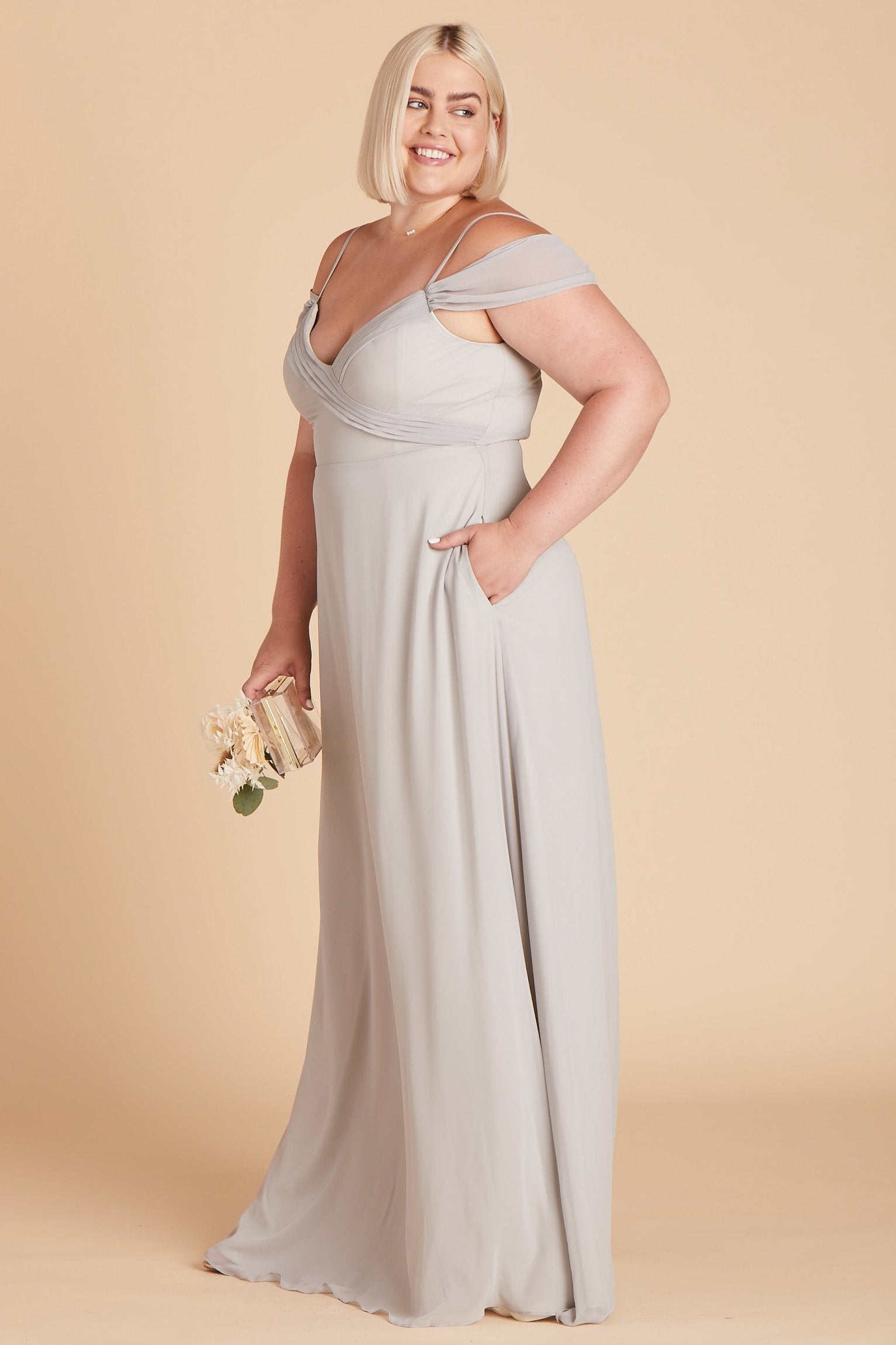 Spence convertible plus size bridesmaid dress in silver chiffon by Birdy Grey, side view with hand in pocket 