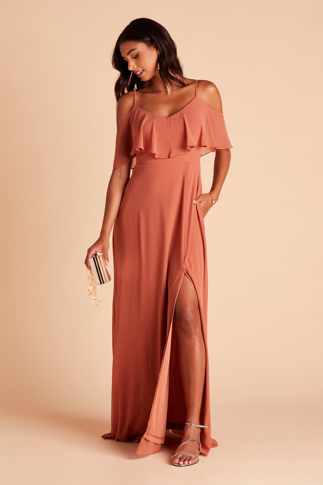 Jane convertible bridesmaid dress with slit in terracotta orange chiffon by Birdy Grey, front view with hand in pocket