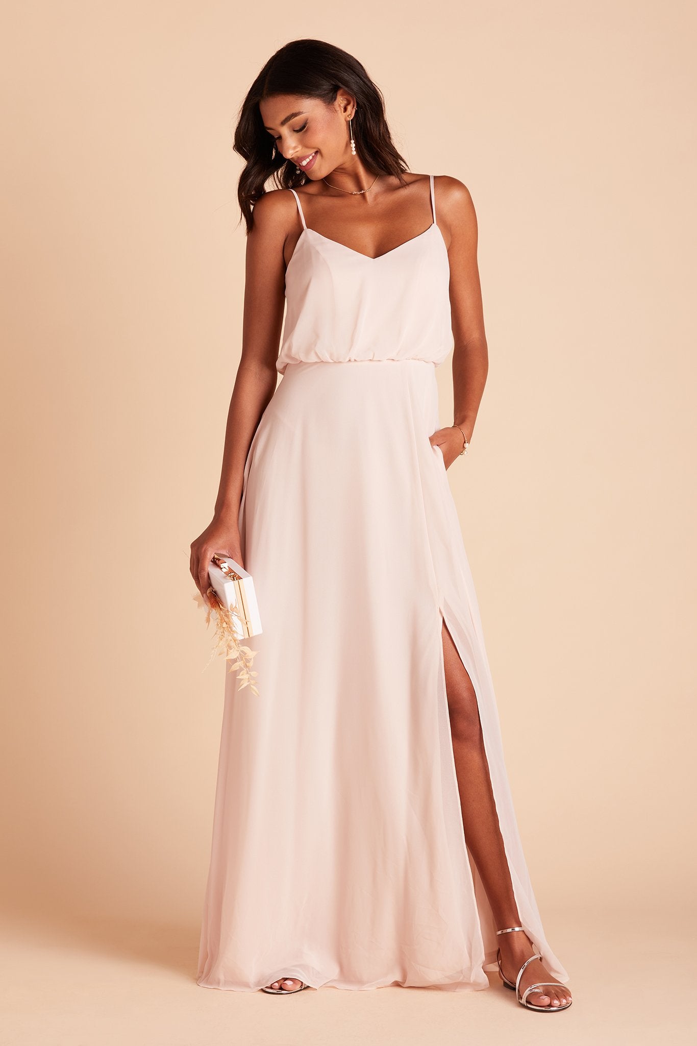 Gwennie bridesmaid dress with slit in pale blush chiffon by Birdy Grey, front view with hand in pocket