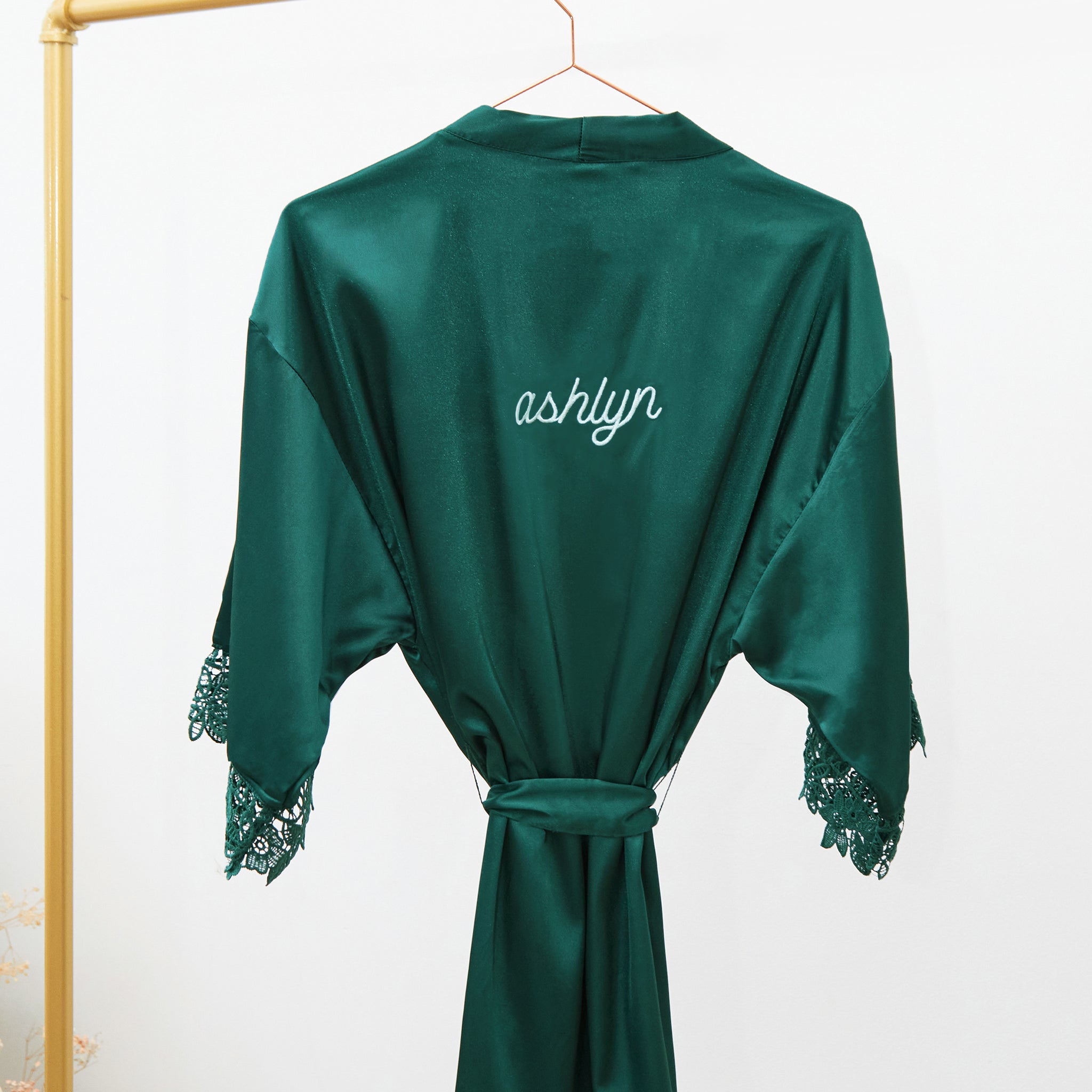 Emerald Claudine satin lace robe on a rack
