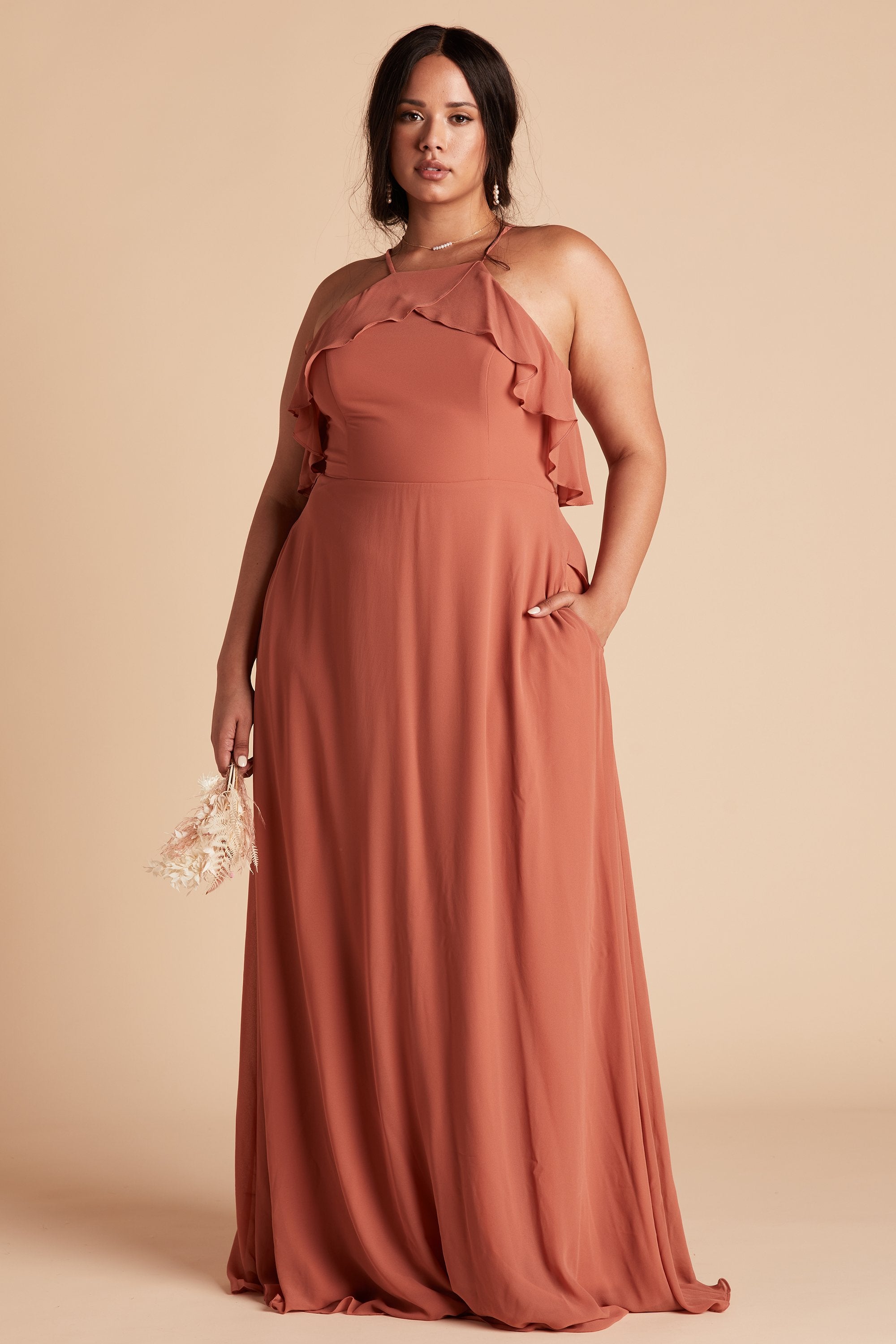 Jules plus size bridesmaid dress in terracotta orange chiffon by Birdy Grey, front view with hand in pocket