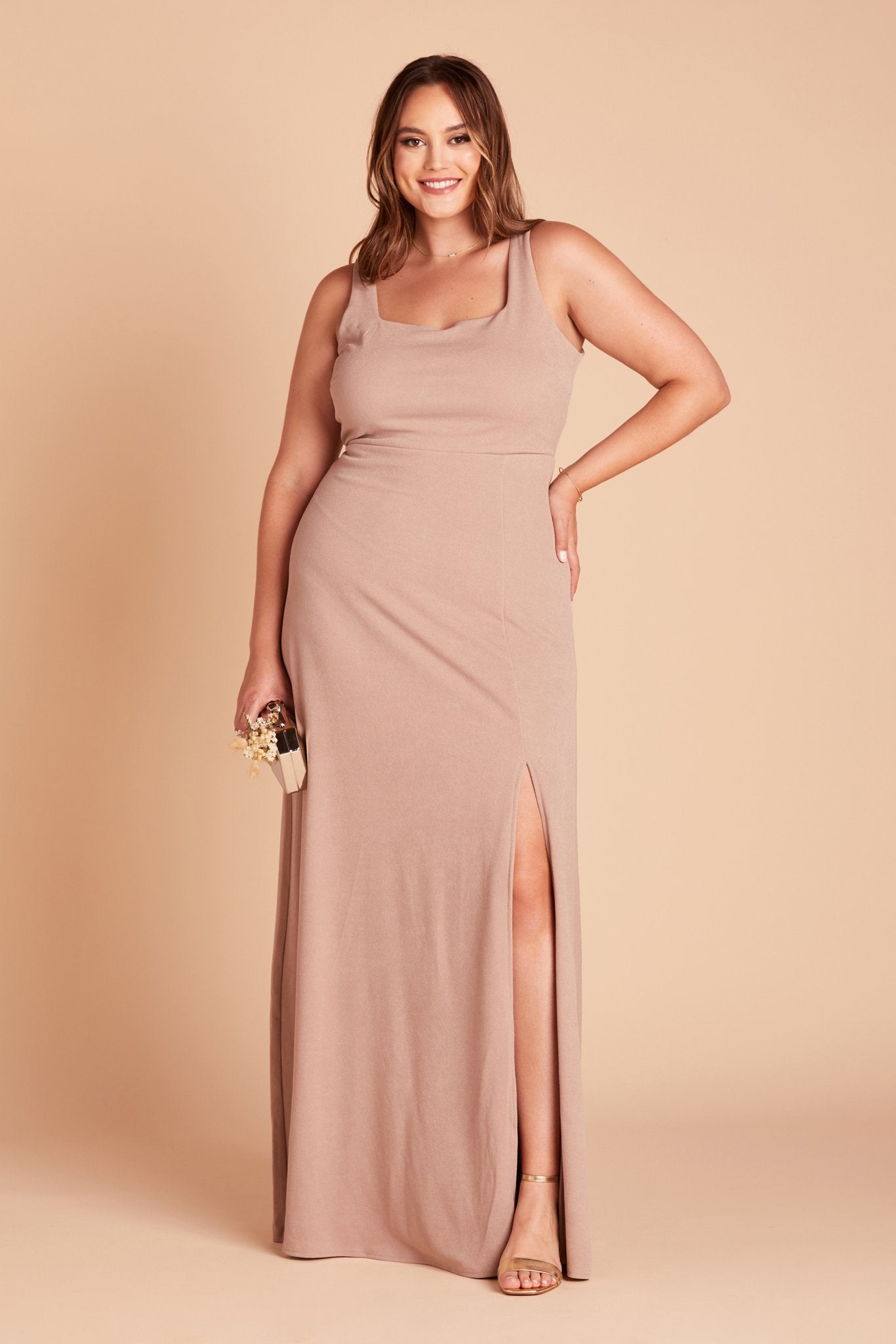 Front view of the Alex Convertible Plus Size Bridesmaid Dress in taupe crepe without shoulder ties worn by a model who is curvy with a medium skin tone.