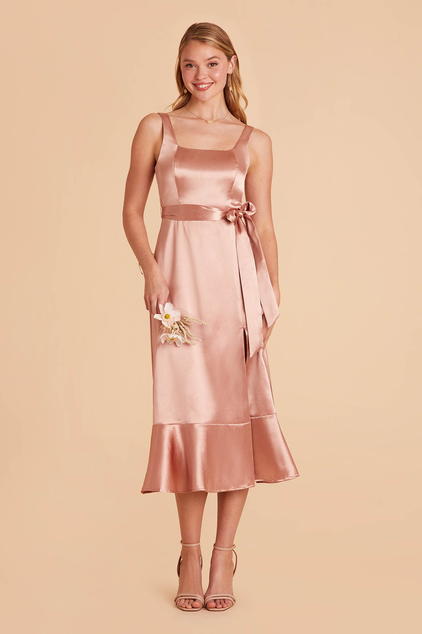 rose gold pink satin convertible pinafore-style midi bridesmaid dress with bow and ruffles
