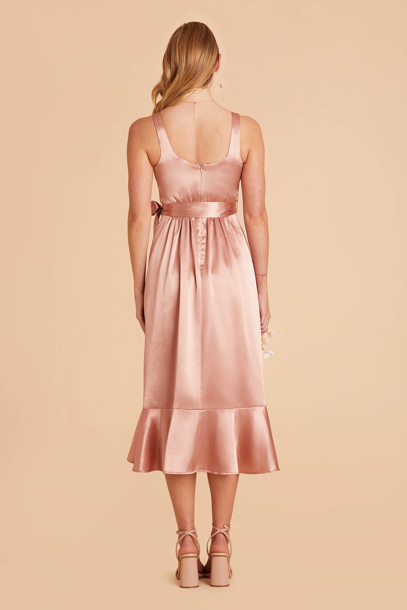 rose gold pink satin convertible pinafore-style midi bridesmaid dress with ruffles