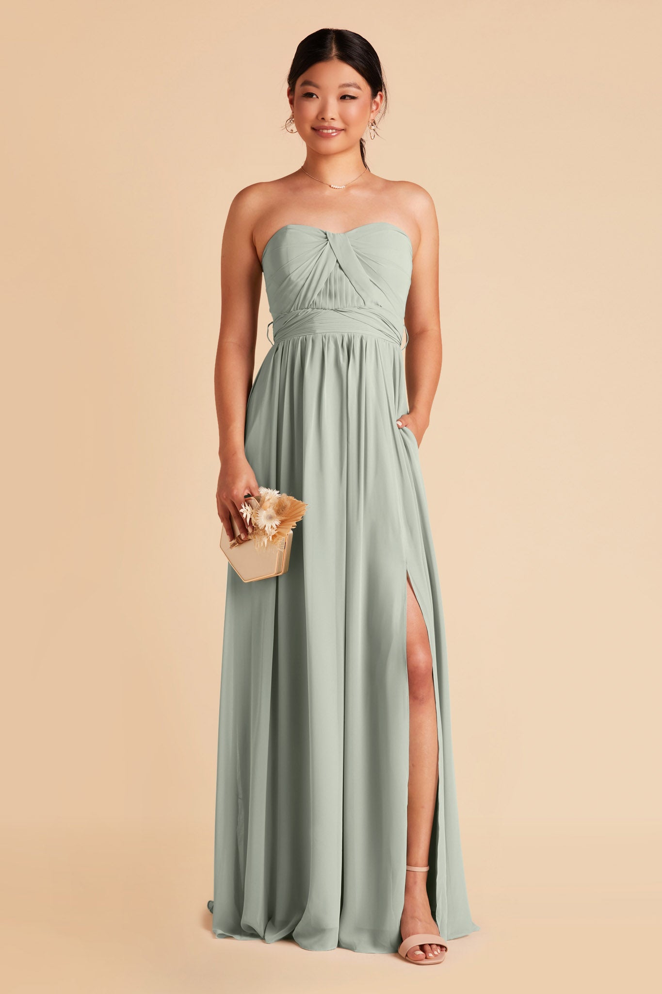 Front view of the Grace Convertible Bridesmaid Dress in sage chiffon by Birdy Grey features a strapless sweetheart neckline and flowing floor-length skirt with hidden pockets.