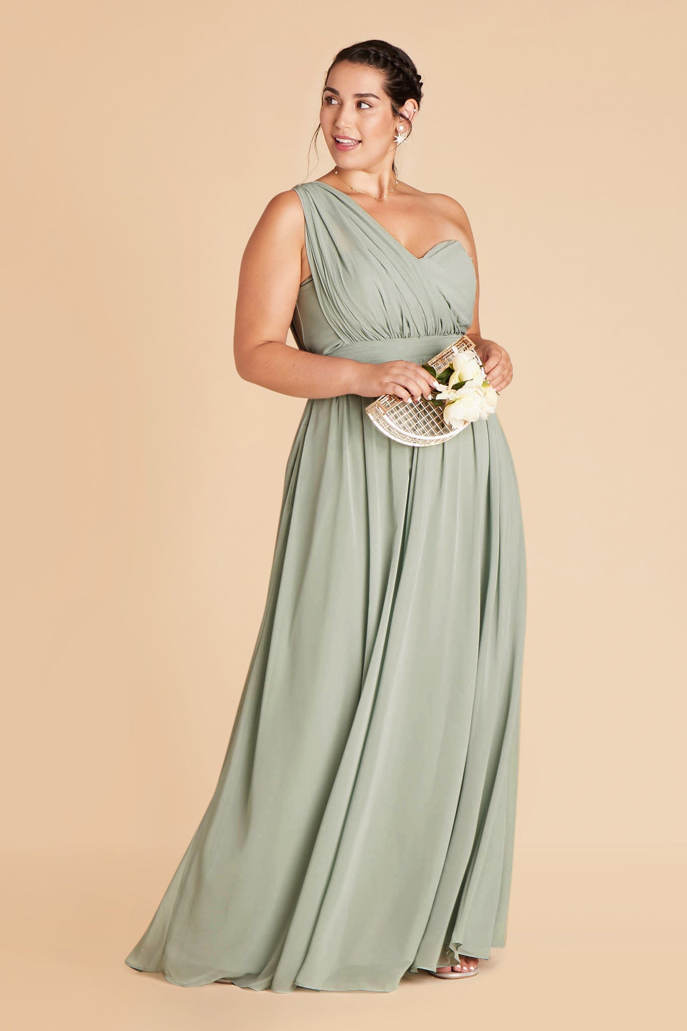 Front view of the floor-length Grace Convertible Plus Size Bridesmaid Dress in sage chiffon with both streamers pulled over the right shoulder for an asymmetrical look.
