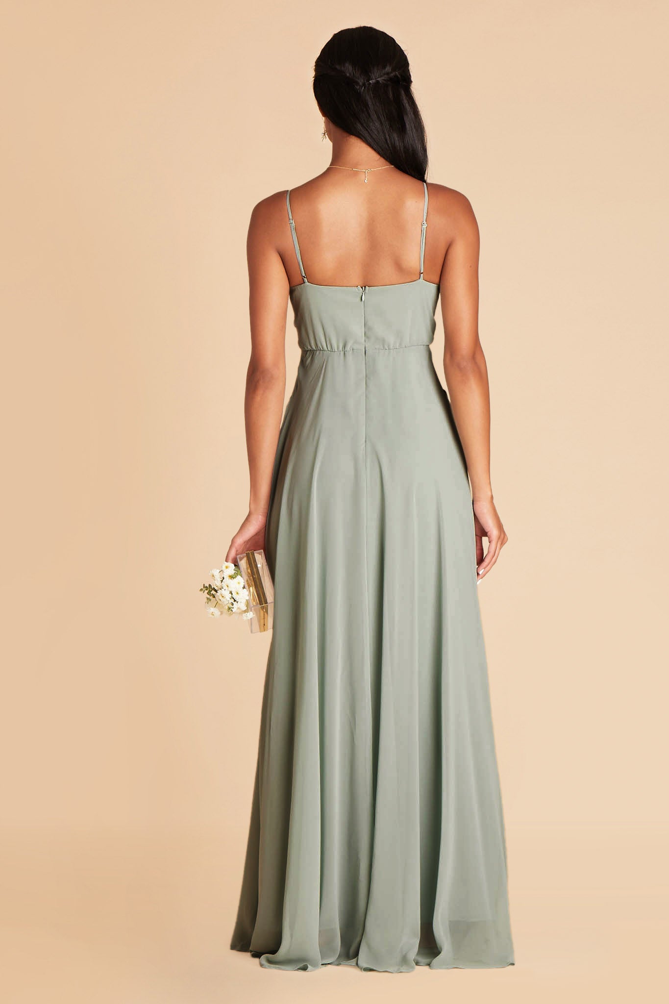 Back view of the Kaia Dress in sage chiffon shows the hook and eye closure and zipper in the center seam of the dress bodice and skirt.