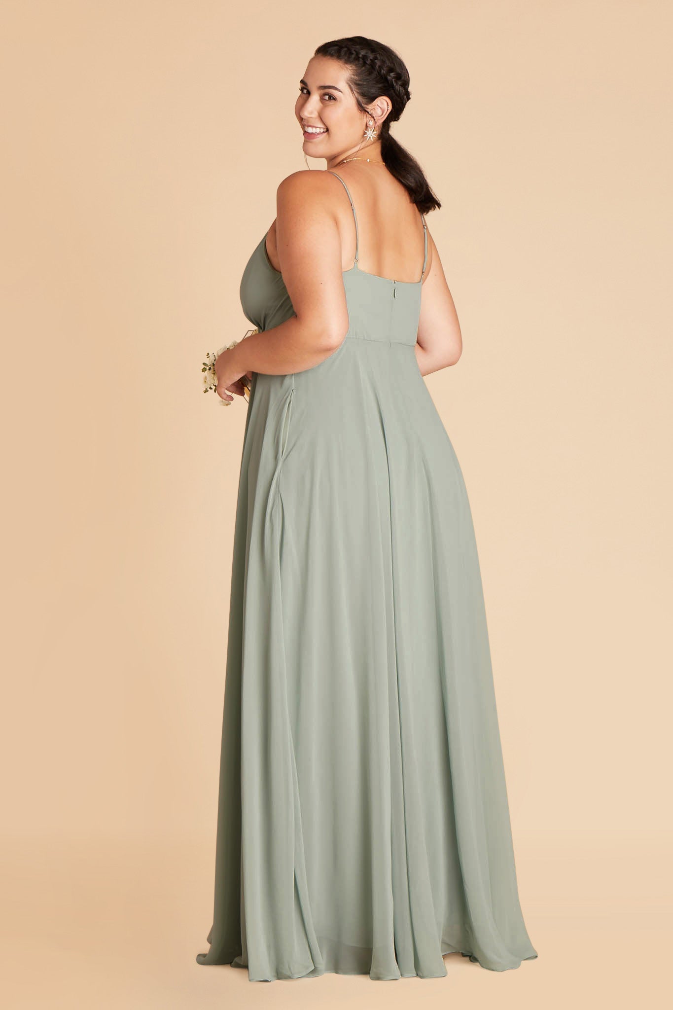 Side and back view of the Kaia Dress in sage chiffon shows a hidden side pocket, adjustable straps, and bodice back with a full length skirt gently gathered at the waist back and flowing to the floor. 